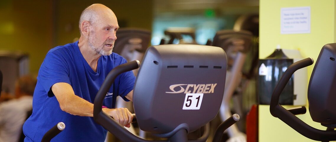 older adult working out in gym