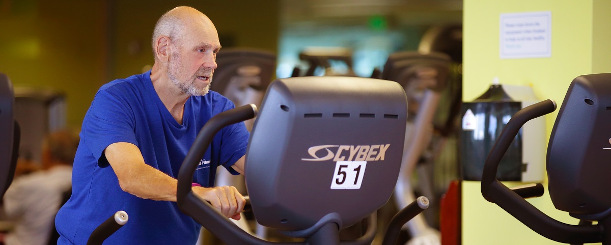 older adult working out in gym