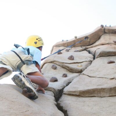 Child scaling a rock wall.