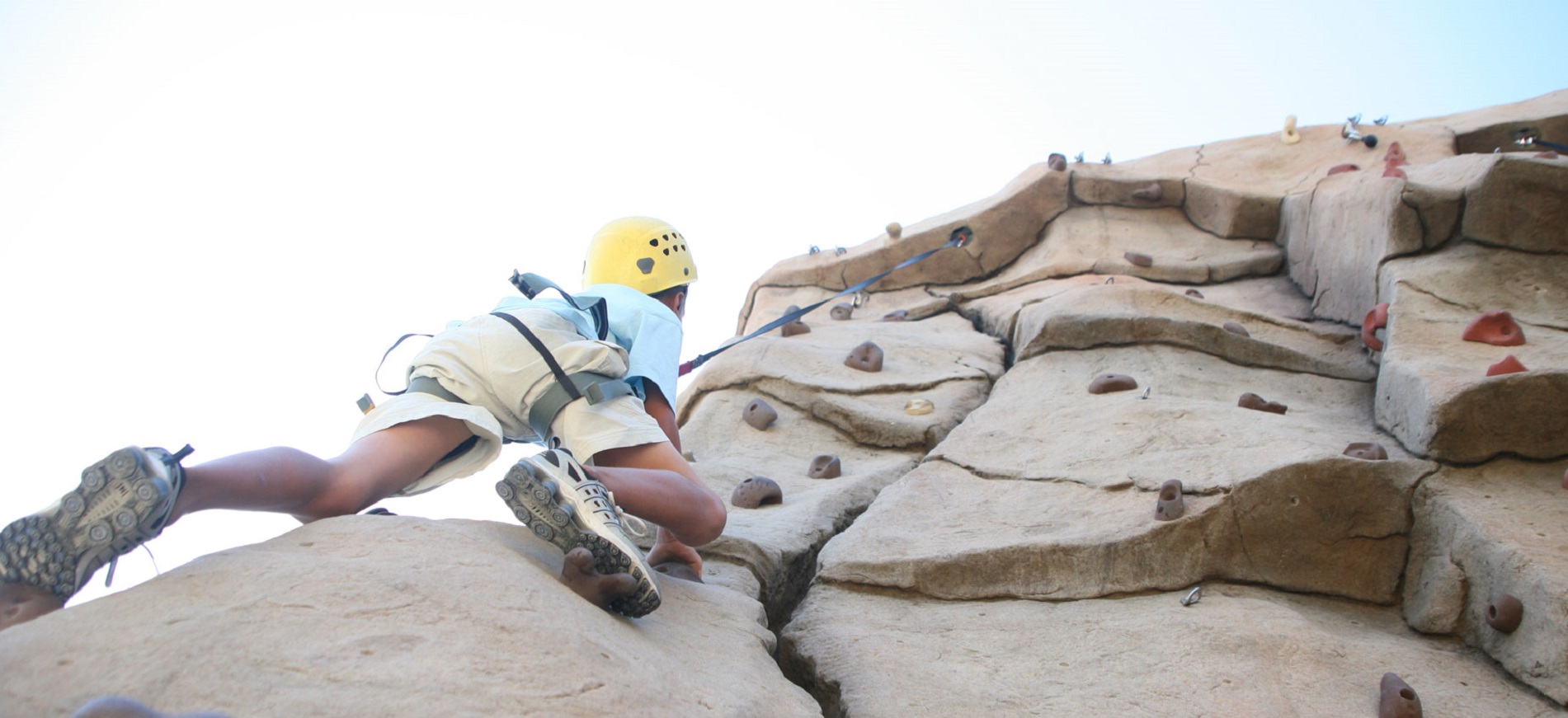 Child scaling a rock wall.