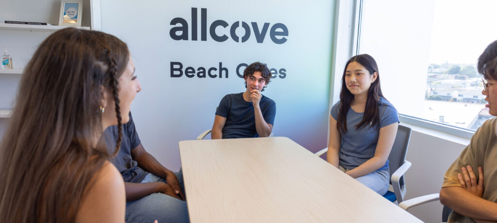 group of youth around table in allcove Beach Cities