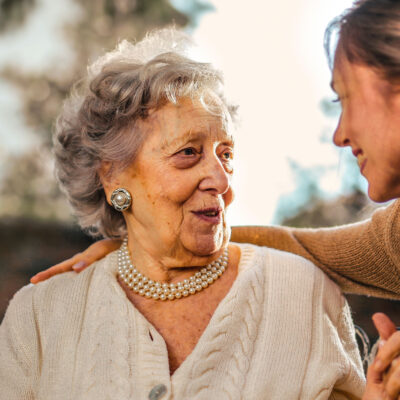 image of an elderly woman and young woman looking happy