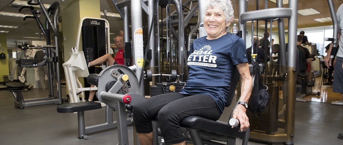 older adult woman working out in gym