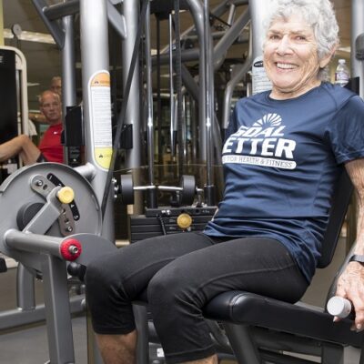 older adult woman working out in gym