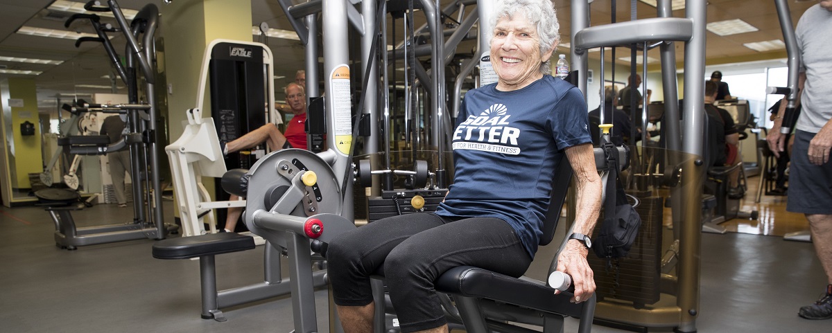 older adult woman working out in gym