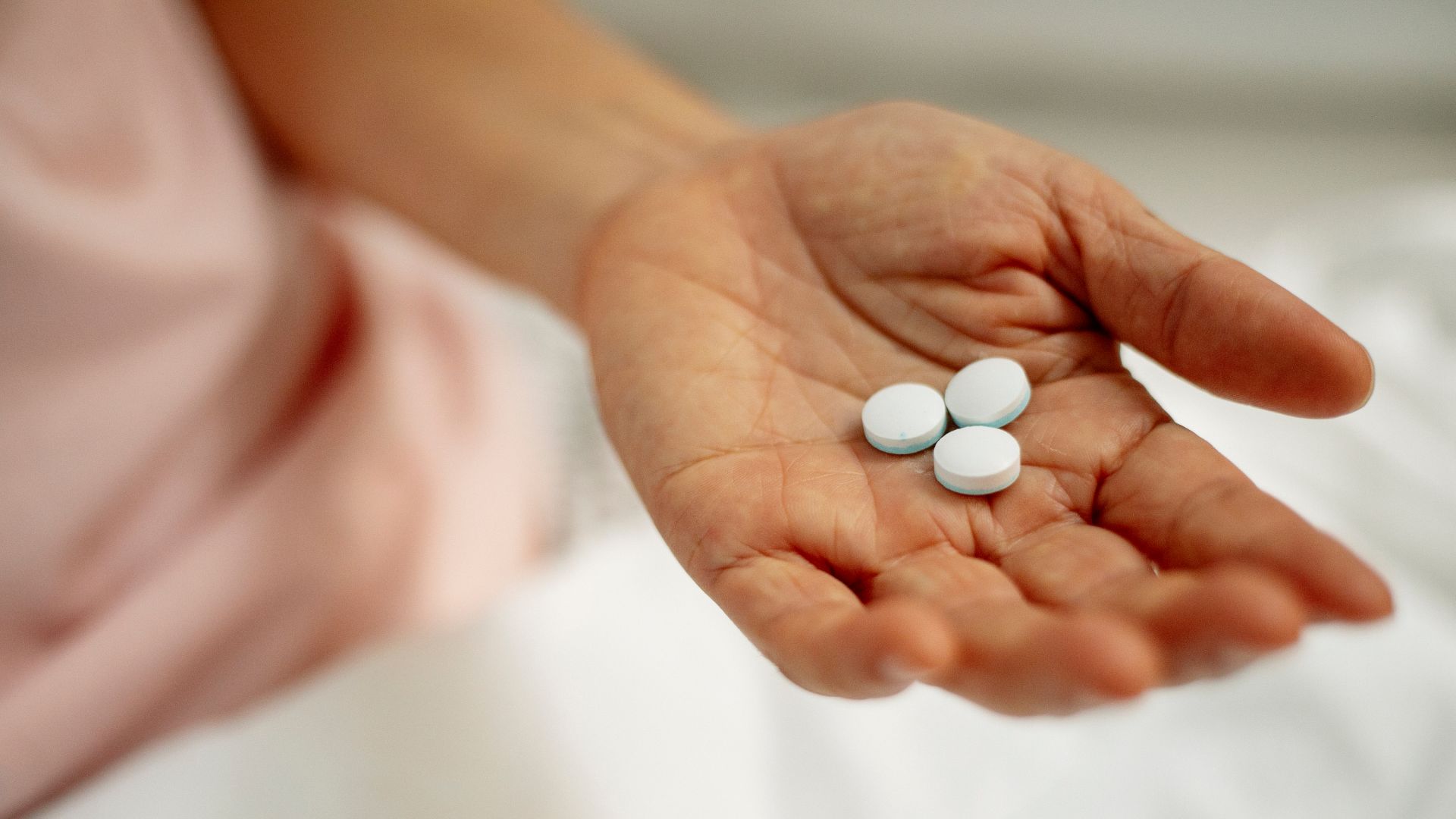 pills in woman hand